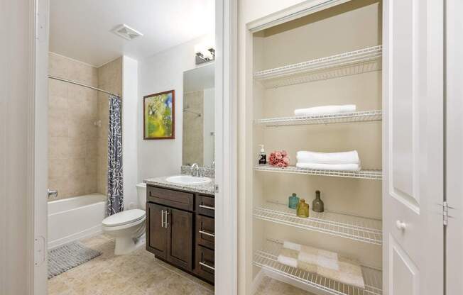 a bathroom with a toilet and a sink and a shower