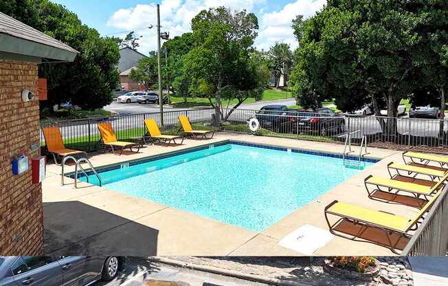 A pool with yellow chairs and a black car in the background.