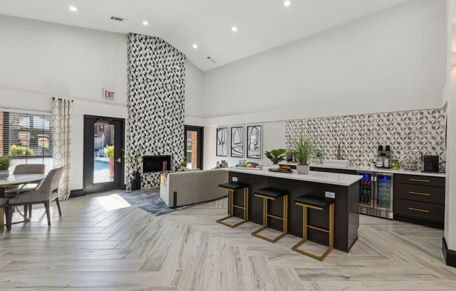 a living room with a kitchen and a fireplace