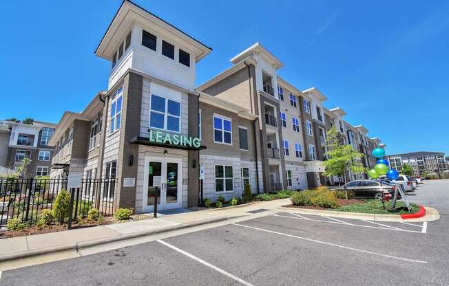 A multi-story building with a leasing sign on the front.