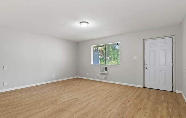 Element at 4411 Macon Apartments A room with a white door and a window with a view of trees.