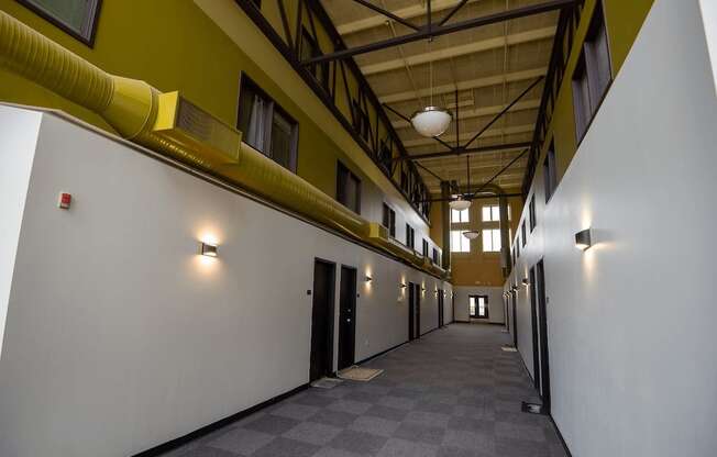 A long hallway with a checkered floor and white walls.