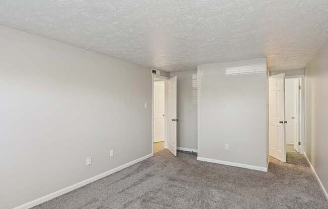 A room with carpeted floor and white walls.