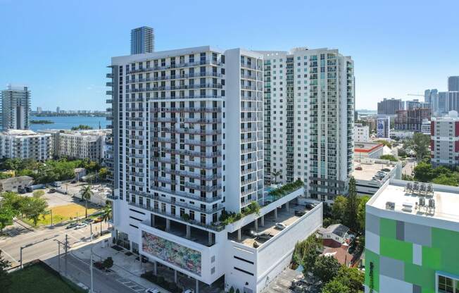 an aerial view of a large white building with many balconies