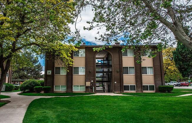 A building with a green lawn in front of it.
