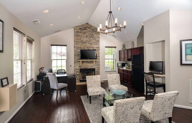 a living room and kitchen with a table and chairs