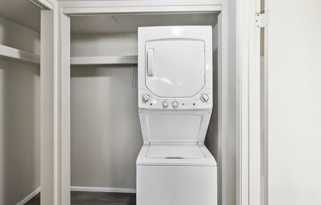 an empty laundry room with a washer and dryer