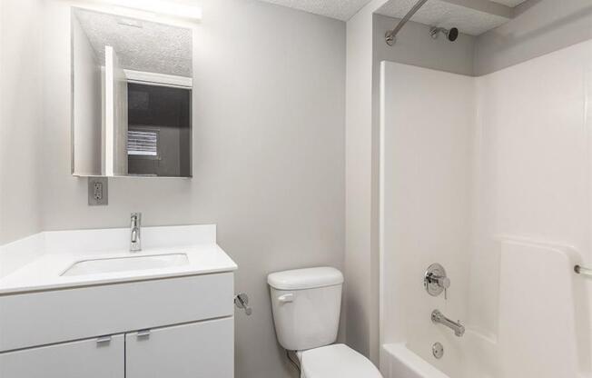 a bathroom with a toilet sink and bathtub