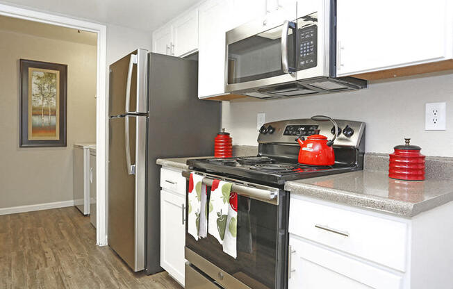 Two-Bedroom Apartments in Richmond CA - Bella Vista At Hilltop - Kitchen With Stainless Steel Appliances and Wood-Style Flooring