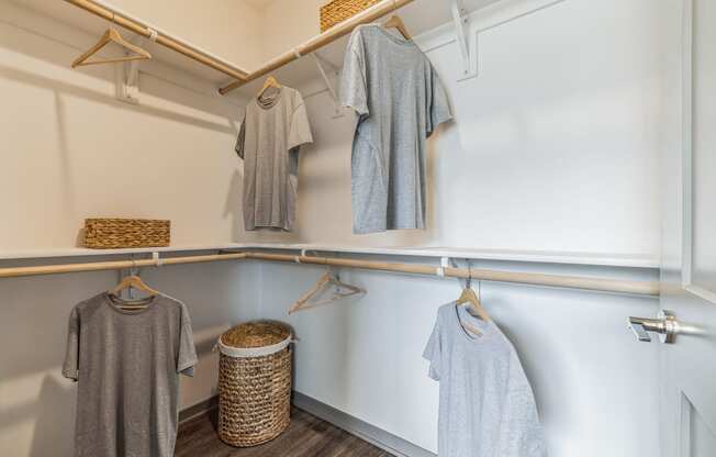 a walk in closet with white walls and wood flooring at Prism at Diamond Ridge, Moon Township