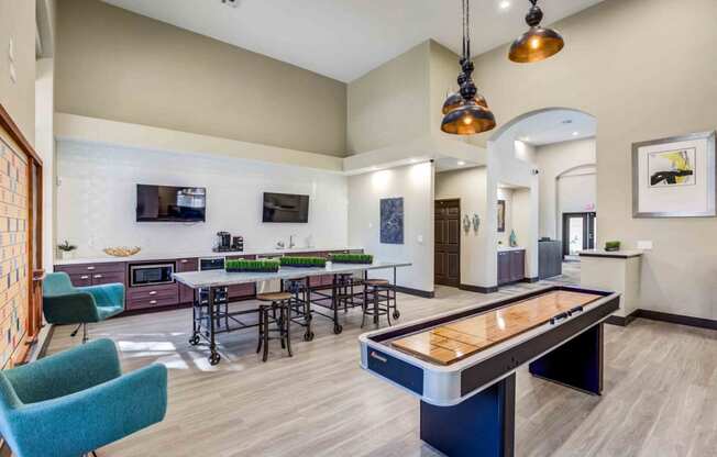 a game room with tables and chairs and a pool table