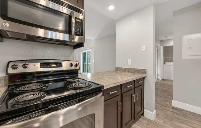 the kitchen in a new home with stainless steel appliances and granite counter tops