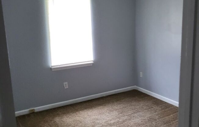 Single family home with covered front porch and back patio.