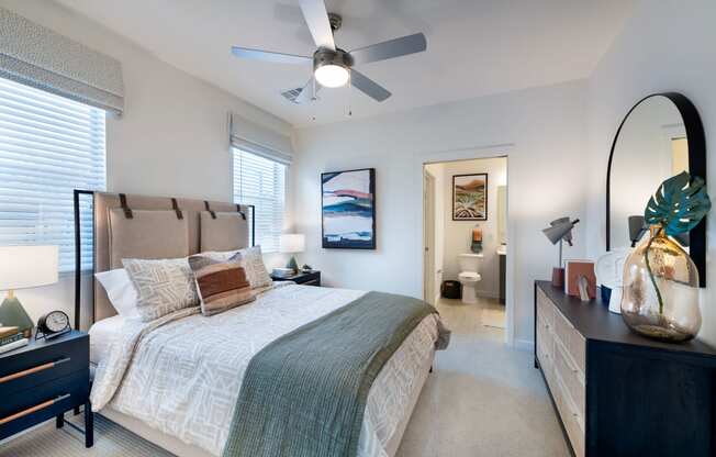 a bedroom with a large bed and a ceiling fan