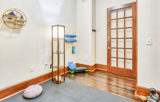 yoga room with hardwood floors and glass wood paneled doors