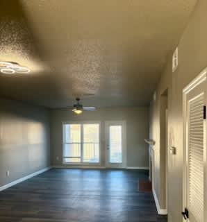 A room with a ceiling fan and a window.