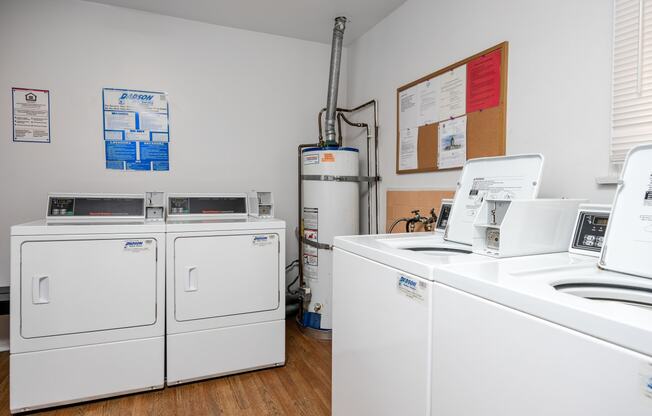 a laundry room with two washers and two washing machines