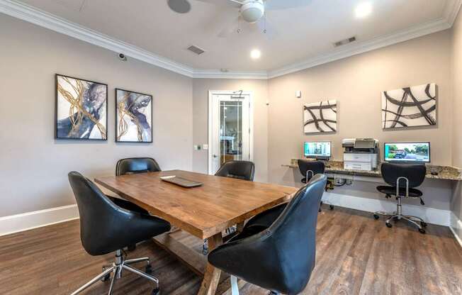 A conference room with a long table and chairs.