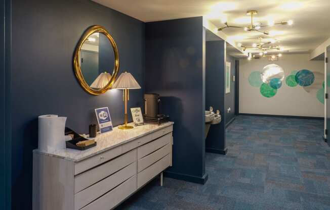 a hallway with a vanity with a mirror and a door to a bathroom at The Commonwealth Building, Pittsburgh, 15222