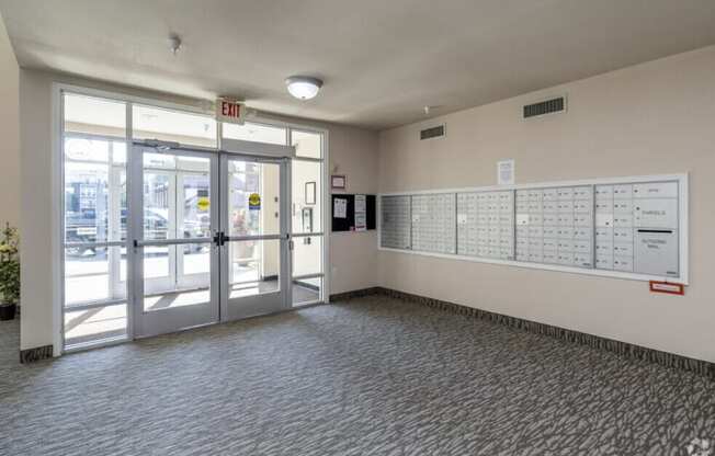 A white board with a schedule is on the wall in a room with a carpeted floor.