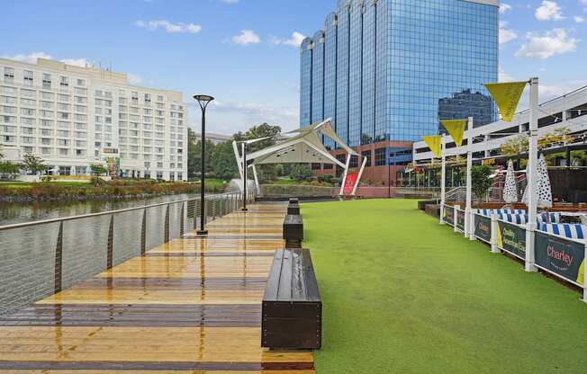 A long wooden boardwalk runs parallel to a body of water.