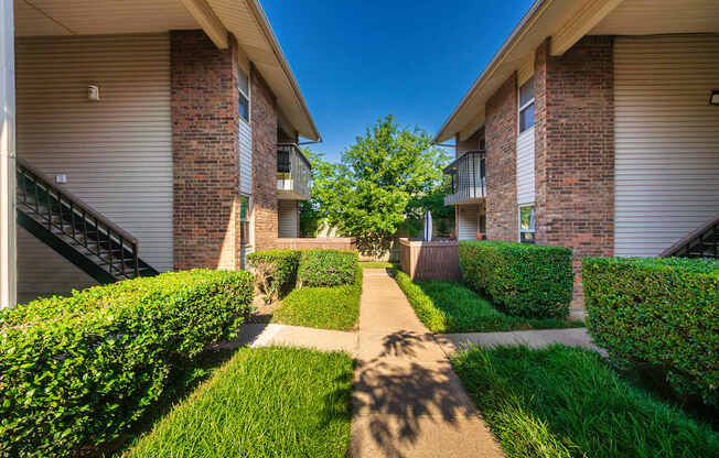Apartment building exteriors showing patios, balconies and landscaping at Preston Park Apartments in the Far North Dallas neighborhood of Dallas, TX
