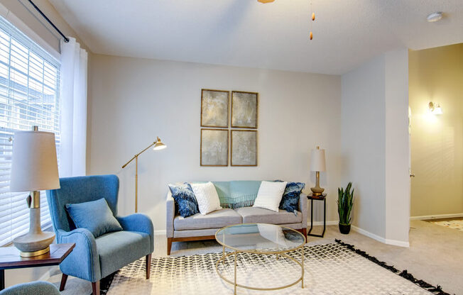 a living room with a couch chair and coffee table