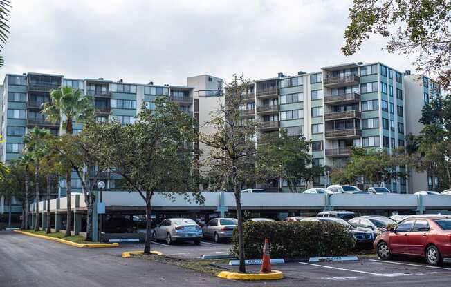 a parking lot with cars in front of an apartment building at Fairways of Inverrary, Florida