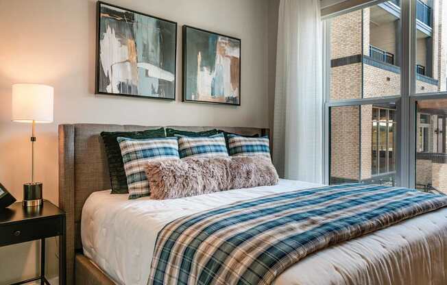 a bedroom with a bed and a large window