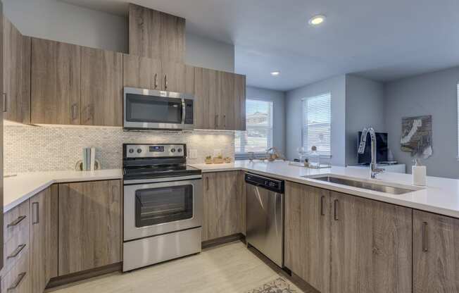 a kitchen with wooden cabinets and stainless steel appliances