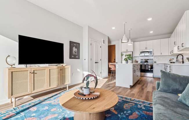 A living room with a television, a coffee table, and a couch.
