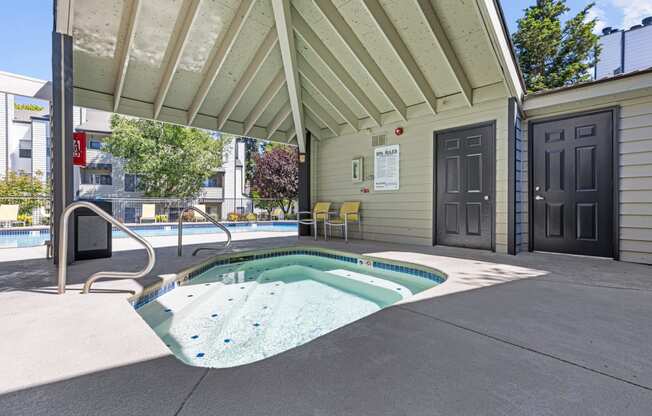 our hot tub is under our covered patio in front of our building with a door