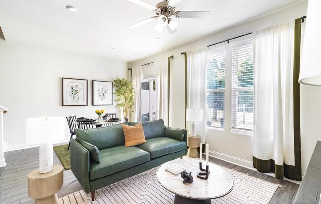 Open-concept floor plans feature spacious living areas, abundant natural light, wood-style flooring, and seamless transitions between the living and dining spaces.