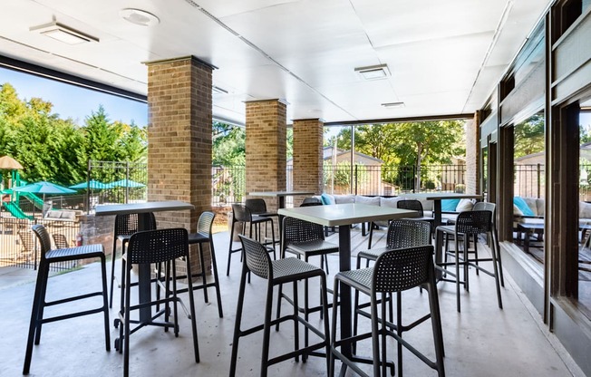 an outdoor patio with tables and chairs at a restaurant