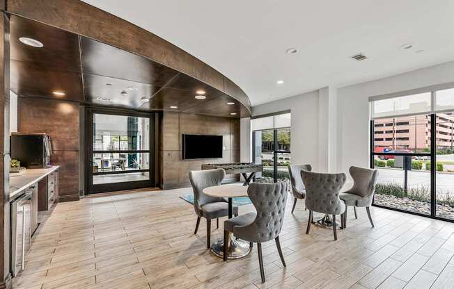 A modern kitchen with a dining table and chairs.