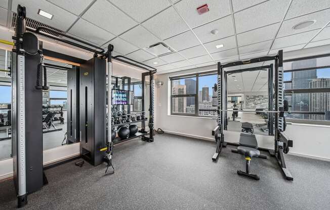 A gym with a view of the city outside the window.