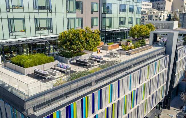 A modern building with a green roof and a glass facade.