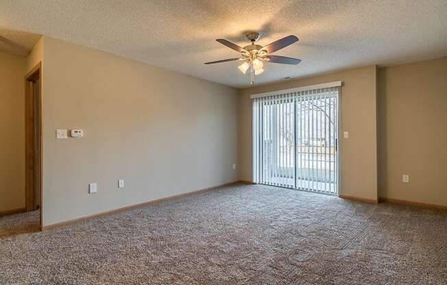 Living room with sliding glass doors at Skyline View Apartments in Lincoln NE