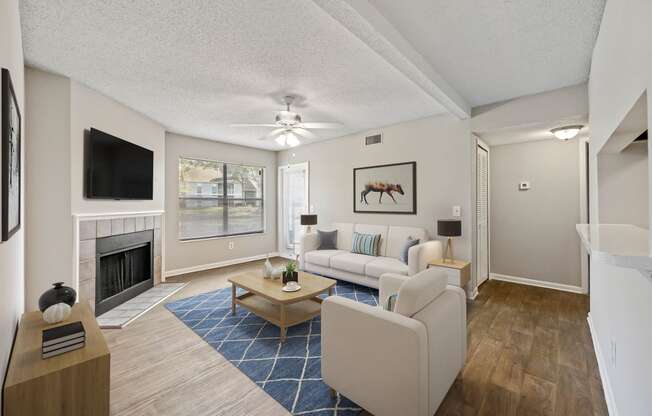 a living room with a fireplace and a large window