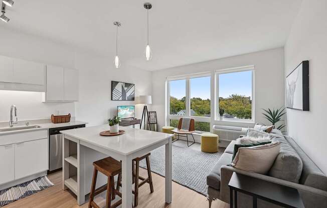 A modern kitchen with a dining table and a couch.