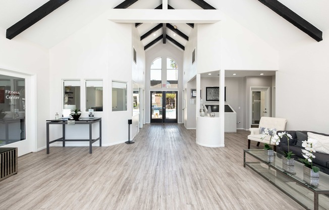 a living room with white walls and wood floors