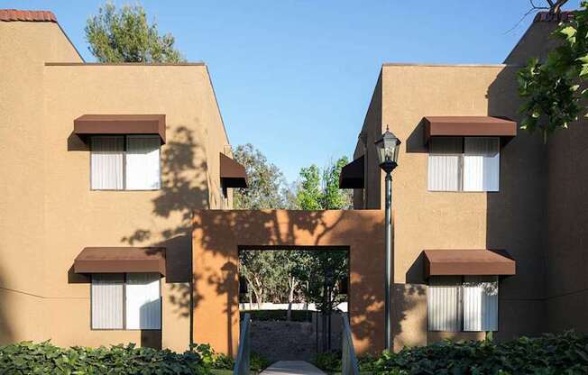 A building with brown and beige walls and white windows.
