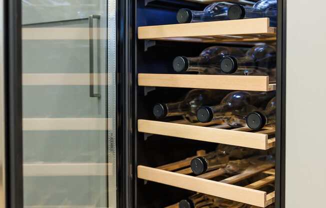 A wine cooler with several shelves of wine bottles.