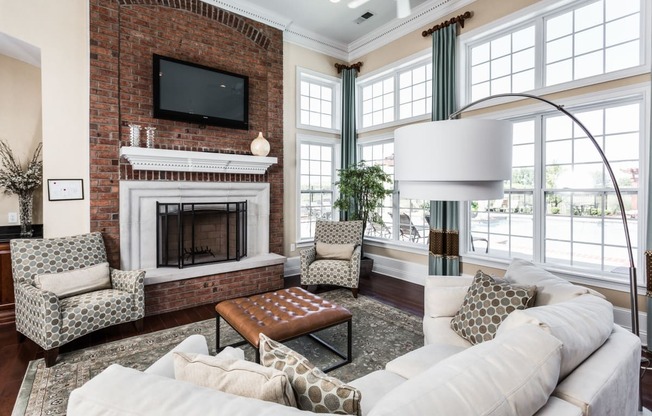 a living room with a white couch and a brick fireplace