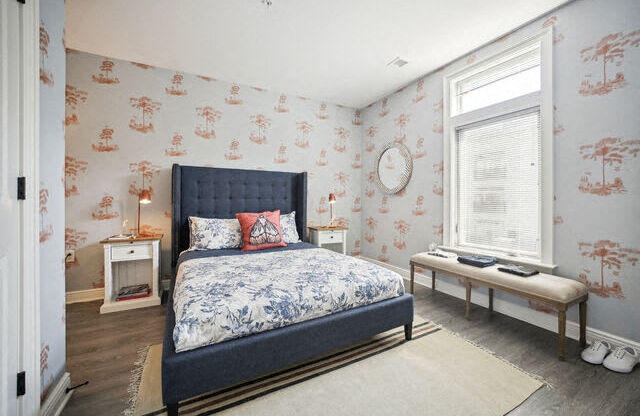 a bedroom with a bed and a window