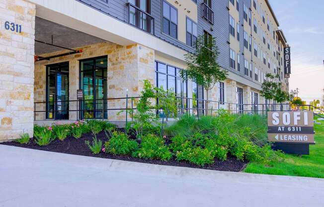 A building with a sign that says "SOFI at 6311" and "4 LEASING".