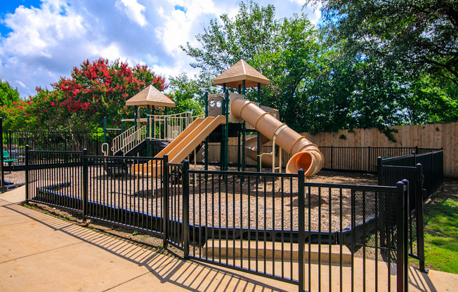 a playground with a slide at a park