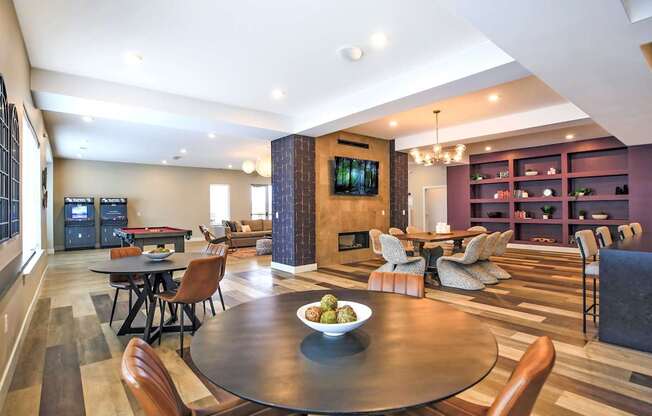 A modern living room with a fireplace and a dining table.