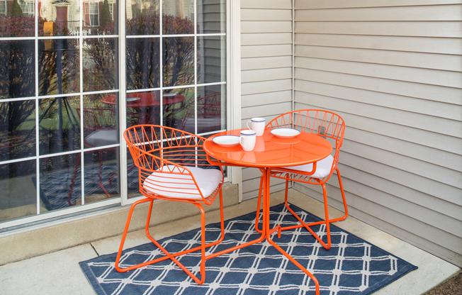 Private patio/balcony with a mini rug and dining table at Westridge Gardens