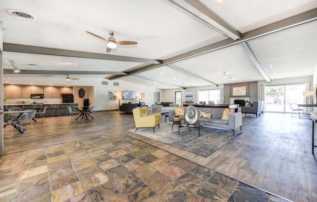 Clubhouse Sitting Area with Hardwood Inspired Floor, Gray Sofa, Rug and Ceiling Fan/Light